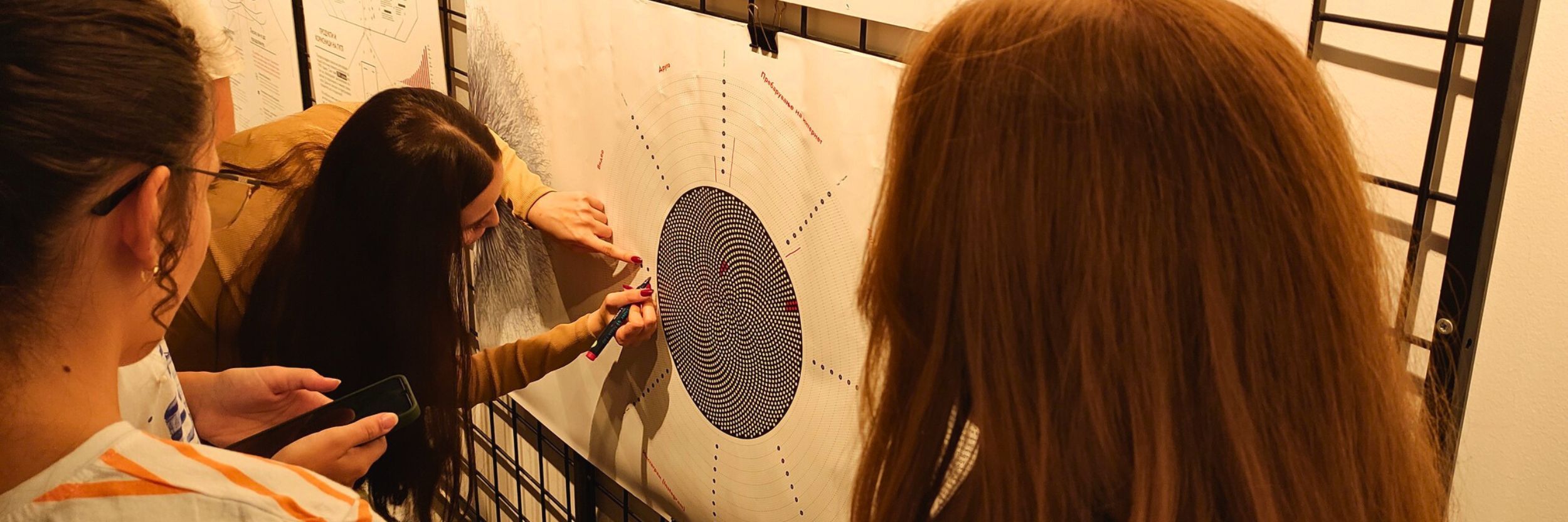 People interacting with a piece of the Glass Room Misinformation
edition exhibition