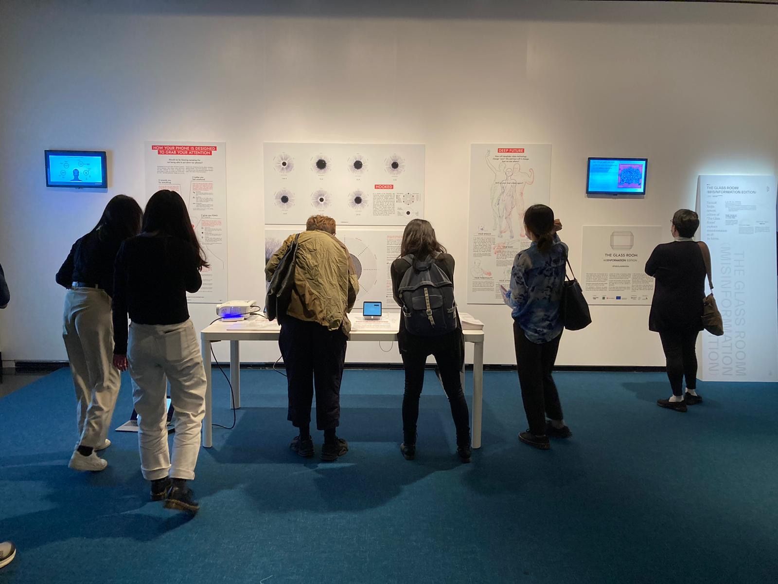 People interacting with the pieces of The Glass Room exhibition