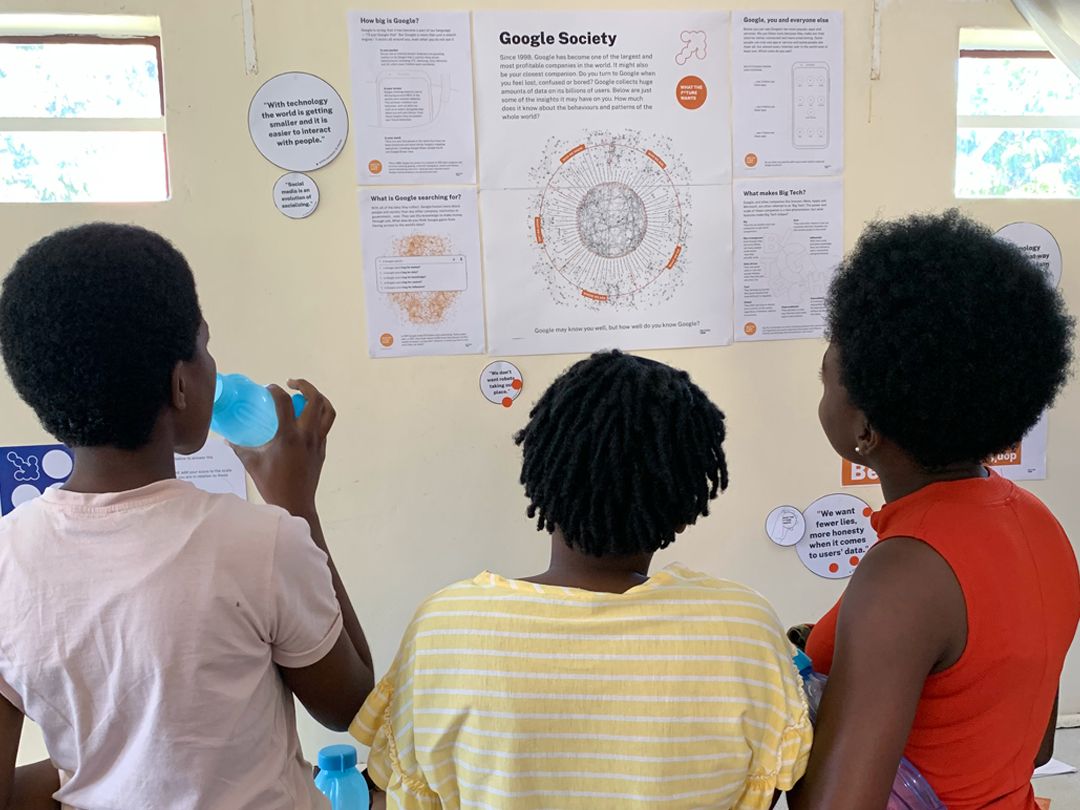An activity from the What the Future Wants exhibition, children
pointing at bubble quotes from the activity.
